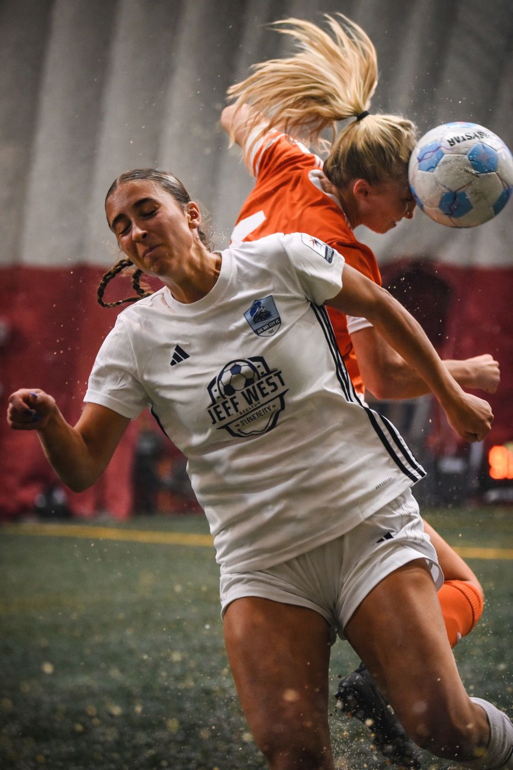 Railway City FC women's player winning an aerial challenge